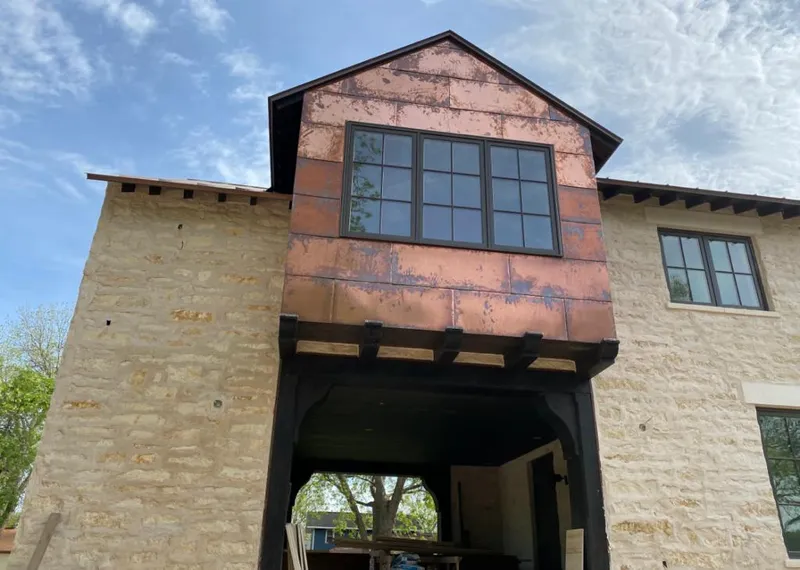 Copper metal panel facade on a stone building for Skylight Installation in Wilmette